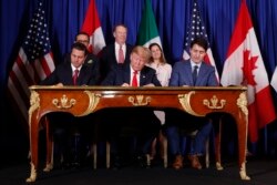 FILE - President Donald Trump, Canada's Prime Minister Justin Trudeau, right, and Mexico's then-President Enrique Pena Nieto, left, participate in the USMCA signing ceremony, Nov. 30, 2018, in Buenos Aires, Argentina.
