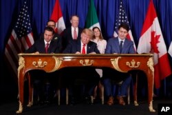 FILE - President Donald Trump, Canada's Prime Minister Justin Trudeau, right, and Mexico's then-President Enrique Pena Nieto, left, participate in the USMCA signing ceremony, Nov. 30, 2018, in Buenos Aires, Argentina.