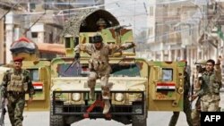 The Iraqi army patrols Baghdad's Fadhil district, Iraq, Tuesday, March 31, 2009. The U.S. military is seeking to reassure its Sunni allies that it would support them despite fears that the Shiite-led government plans a purge of their ranks after a weekend