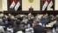 FILE - Iraqi Prime Minister Haider al-Abadi, center, attends a session of the Iraqi Parliament, in Baghdad, Iraq, Sept. 27, 2017. Iraq's Kurdish lawmakers are reportedly ending to their boycott of the national parliament.