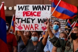 FILE - People take part in a protest by Armenian Youth Federation against what they call Azerbaijan's aggression against Armenia and the breakaway Nagorno-Karabakh region outside the Azerbaijani Consulate General in Los Angeles, California.