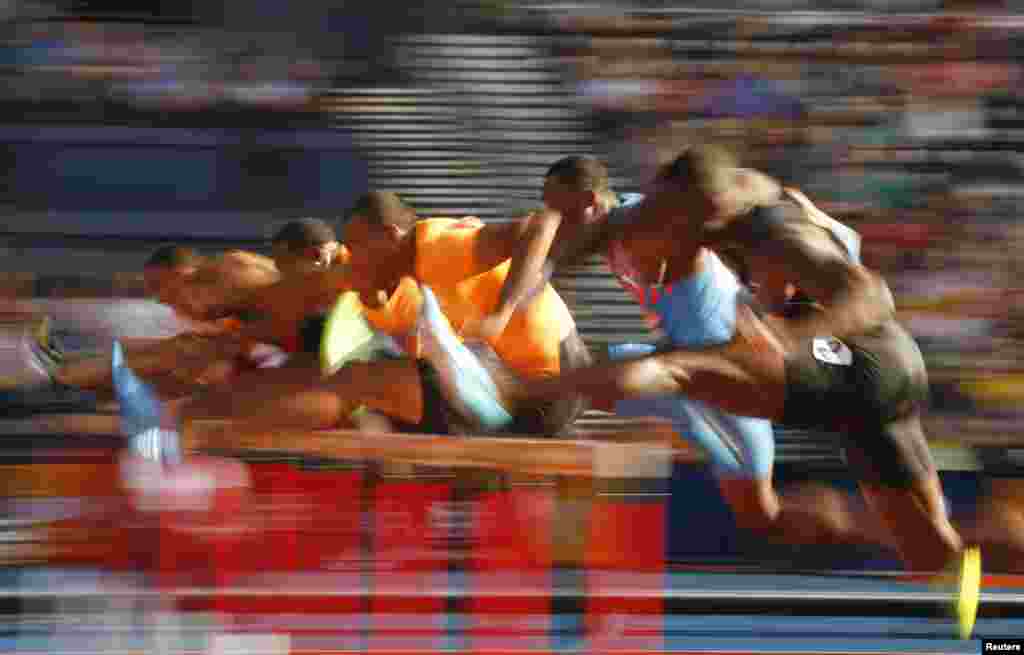 Competitors clear hurdles during a heat of the men&#39;s 110m hurdles during the IAAF Diamond League athletics meeting at Hampden Park in Glasgow, Scotland.