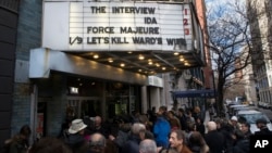 Patrons wait in line to see "The Interview" at the Cinema Village movie theater, Dec. 25, 2014, in New York.