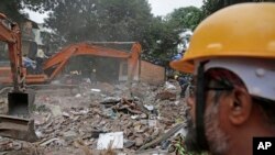 Rescuers look for survivors on the second day after a five-story building collapsed in the Ghatkopar area of Mumbai, India, July 26, 2017.