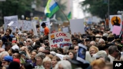 People fill 58th Street between 8th and 9th Avenue before a climate changes protest march in New York, Sept. 21, 2014.