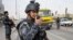Iraqi federal policemen stand guard at a checkpoint in Basra Jan. 2, 2014. The Iraqi government has tightened security measures after security forces reportedly arrested al-Mukhtar Army commander, Wathiq al-Batat.