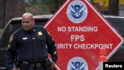 A federal security officer stands at a checkpoint outside the Jacob Javits Federal office building in New York, October 29, 2014. The United States is increasing security at government buildings in Washington and other cities because of continuing terror