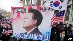 Supporters of impeached South Korean President Yoon Suk Yeol attend a rally to oppose his impeachment near the Constitutional Court in Seoul, South Korea, Feb. 25, 2025. The letters read, "The people's president."