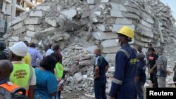 Emergency personnel stands by the debris of the collapsed building in Ikoyi, Lagos, Nigeria, Nov. 1, 2021. 