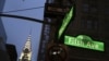 FILE - Signs for Fifth Avenue and 42nd Street and the Chrysler Building are illuminated, in New York City, Nov. 18, 2013.