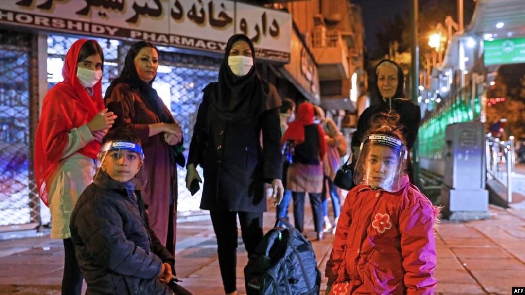 Iranians wearing masks against the coronavirus gather outside their buildings after an earthquake was felt in the capital, Tehran, on May 7, 2020. 