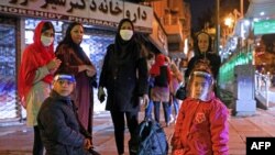 Iranians wearing masks against the coronavirus gather outside their buildings after an earthquake was felt in the capital, Tehran, on May 7, 2020. 