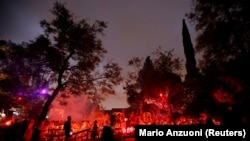 People walk by a house which is decorated for Halloween in Sierra Madre, California, U.S.