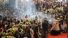 Incense is spread during a funeral service for some of the victims of a collapsed highway bridge, in Genoa's exhibition center Fiera di Genova, Italy, Saturday, Aug. 18, 2018.