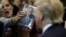 FILE - A woman thrusts Republican Donald Trump's book at him for an autograph at his campaign rally in Manassas, Virginia, Dec. 2, 2015. Trump said at the time that his plan for combating Islamic State militants involved targeting not just the group's fighters but also their families.