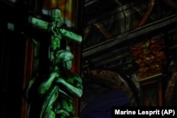 Video projections are seen at the Saint-Sulpice church in Paris, Oct. 31, 2024. (AP Photo/Marine Lesprit)