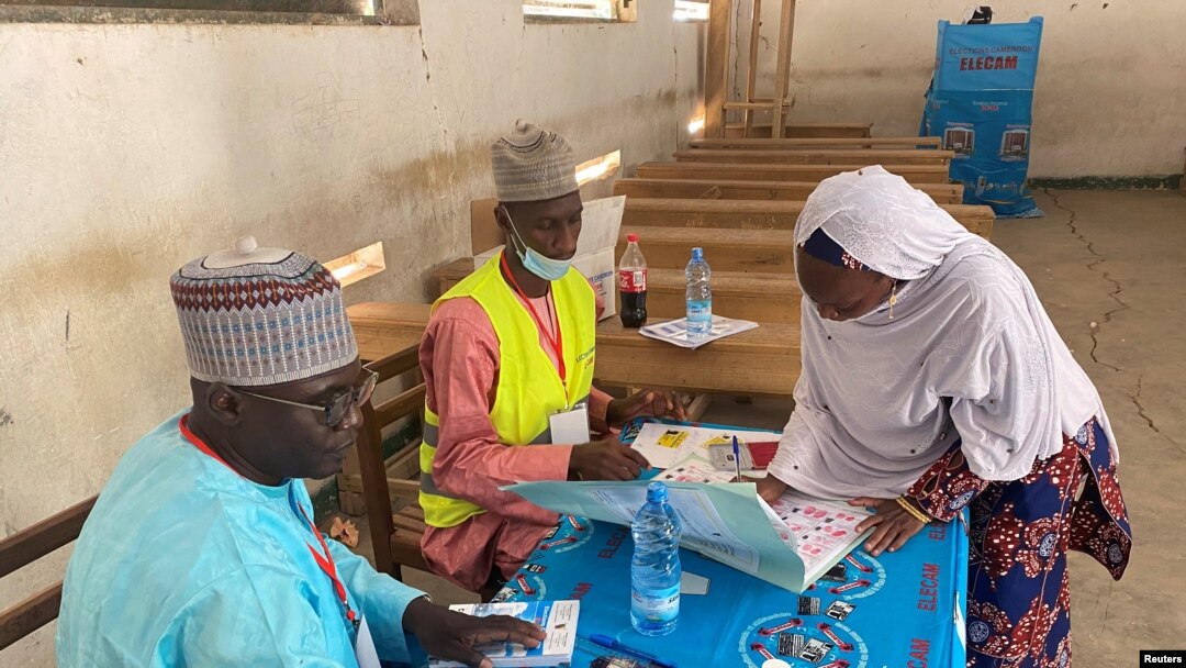 A voter signs after casting her ballot during the first regional election in Maroua, Cameroon, Dec. 6, 2020. 