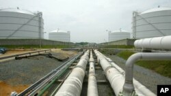 FILE - Pipelines running from the offshore docking station to four liquefied natural gas (LNG) tanks at the Dominion Resources Inc. Liquefied Natural Gas facility in Cove Point, Maryland, are seen in a June 13, 2003, photo.