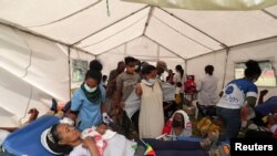 A volunteer donates blood for the injured members of Ethiopia's National Defense Forces fighting against Tigray's special forces on the border between Amhara and Tigray, at the stadium in Addis Ababa, Ethiopia Nov. 12, 2020.