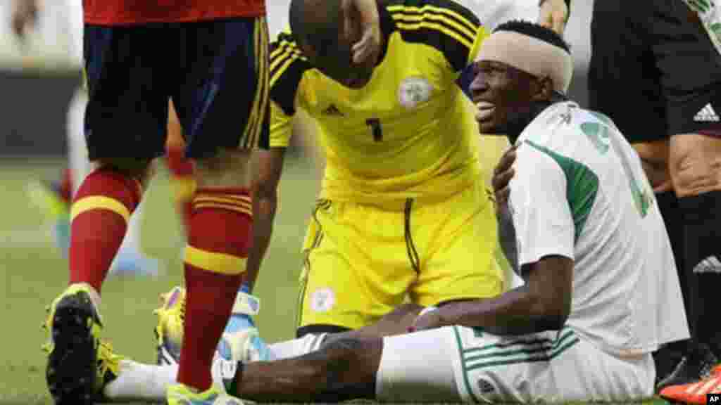 Nigeria's Kenneth Omeruo, right, is attended by goalkeeper Vincent Enyeama as he holds his shoulder after being injured.