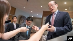 Chinese Ambassador to the U.N. and current Security Council President Liu Jieyi, right, speaks to reporters during a break in a Security Council meeting on the situation in the Middle East, including the Palestinian question, July 25, 2017 at United Nations headquarters in New York. 