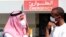 Men wear surgical masks as a precautionary measure against novel coronavirus, Dammam, Saudi Arabia, May 23, 2013.