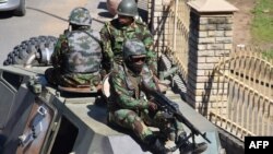 FILE - Members of the Lesotho Defense Force patrol the town of Maseru, April 18, 2020. 