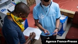 An electoral commission official prepares to seals ballot boxes at the Fordsburg Primary School polling station under the supervision of party delegates during local elections, in Johannesburg, South Africa, Nov. 1, 2021.