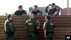 Ronald Vitiello, sous-commissaire par intérim de la Protection des frontières, et deux autres agents, échangent avec leurs homologues de la police fédérale mexicaine à Tijuana, au Mexique, le 26 octobre 2017.