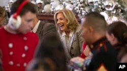 First lady Jill Biden laughs during a Toys for Tots event with Marine Corps families in the East Room at the White House in Washington, Dec. 13, 2024.