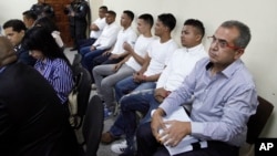Men accused in the killing prize-winning Honduran indigenous and environmental rights activist Berta Caceres sit in a court room in Tegucigalpa, Honduras, Sept. 17, 2018. 