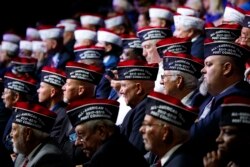 FILE - Audience members listen as President Donald Trump speaks during the Veterans of Foreign Wars of the United States National Convention, July 24, 2018, in Kansas City, Mo.