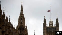 FILE - The British union flag flies at half-mast above Victoria Tower on the Palace of Westminster, in London, June 20, 2016.