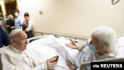 Pope Francis speaks with a patient at the Gemelli hospital as he recovers following scheduled surgery on his colon, in Rome, Italy, July 11, 2021. (Vatican Media/­Handout)