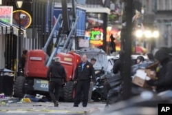 Emergency services work on Bourbon Street after a vehicle drove into a crowd on Canal and Bourbon streets in New Orleans, Louisiana, Jan. 1, 2025.