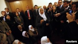 Pro-Kurdish demonstrators calling themselves 'Peace Mothers' (C) hold a sit-in protest against air strikes on the Iraqi border that killed 34 Turkish Kurd smugglers, in front of the office of Turkish Prime Minister Tayyip Erdogan at the parliament in Anka