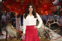 Voice actress Idina Menzel, poses for photographers alongside reindeer, upon arrival at the European premiere of "Frozen 2" in central London, Nov. 17, 2019.