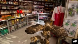  FILE -- A North Korean woman stands behind the counter at a souvenir shop in Rajin, North Korea, inside the Rason Special Economic Zone. North Korea recently laid out new laws to facilitate foreign tourism and investment.