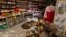  FILE -- A North Korean woman stands behind the counter at a souvenir shop in Rajin, North Korea, inside the Rason Special Economic Zone. North Korea recently laid out new laws to facilitate foreign tourism and investment.