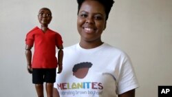 Jennifer Pierre, of Fort Lauderdale, Fla., a student at Babson College, holds her prototype doll named Jaylen at the school, in Wellesley, Mass.