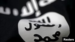 FILE - An Islamic State flag is seen in this photo illustration.