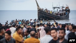Newly arrived Rohingya refugees return to a boat after the local community decided to temporarily allow them to land for water and food in Ulee Madon, Aceh province, Indonesia, on Nov. 16, 2023.