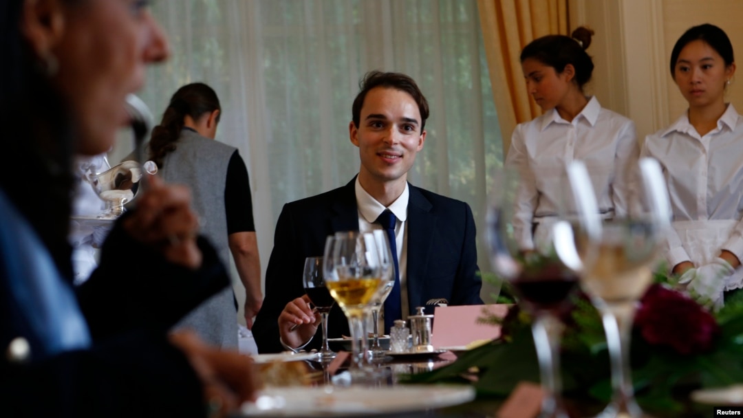 Guillaume, a French student takes part in a conversation role during a session on English dining during the Intensive Etiquette Courses at the Institut Villa Pierrefeu in Glion near Montreux, western Switzerland, October 22, 2013. 