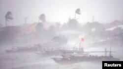 Rough waters from Typhoon Rammasun toss fishing boats off the coast of the Philippines. (July 16, 2014.)