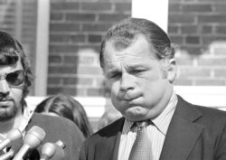 FILE - F. Lee Bailey, defense lawyer for Capt. Ernest L. Medina, puffs out his cheeks as he talks with reporters at end of court session at Fort McPherson, Ga., Sept. 15, 1971.