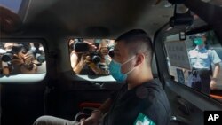 FILE - Tong Ying-kit arrives at a court in a police van in Hong Kong, July 6, 2020. Tong, the first person to be tried under Hong Kong's sweeping national security law was found guilty of secessionism and terrorism, July 27, 2021.