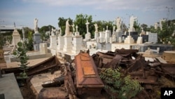 Looted coffins lay in a pile after grave robbers moved through El Cuadrado cemetery in Maracaibo, Venezuela, May 16, 2019. 