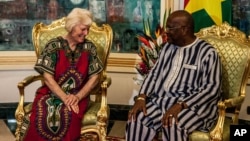 Australian Jocelyn Elliott, left, who was freed by al-Qaida captors, meets Burkina Faso President Roch Marc Christian Kaboré, right, at the presidential palace in Ouagadougou, Feb. 8, 2016.