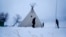 Snow lays on the ground as campers from Colorado set up a teepee at the Oceti Sakowin camp where people have gathered to protest the Dakota Access oil pipeline near Cannon Ball, N.D., Nov. 30, 2016.