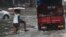 Indian boys navigate their way through a waterlogged street in Mumbai, India, Sept. 20, 2017.